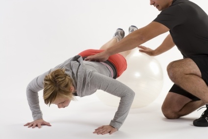 Image of Personal Trainer with Client on Fitball