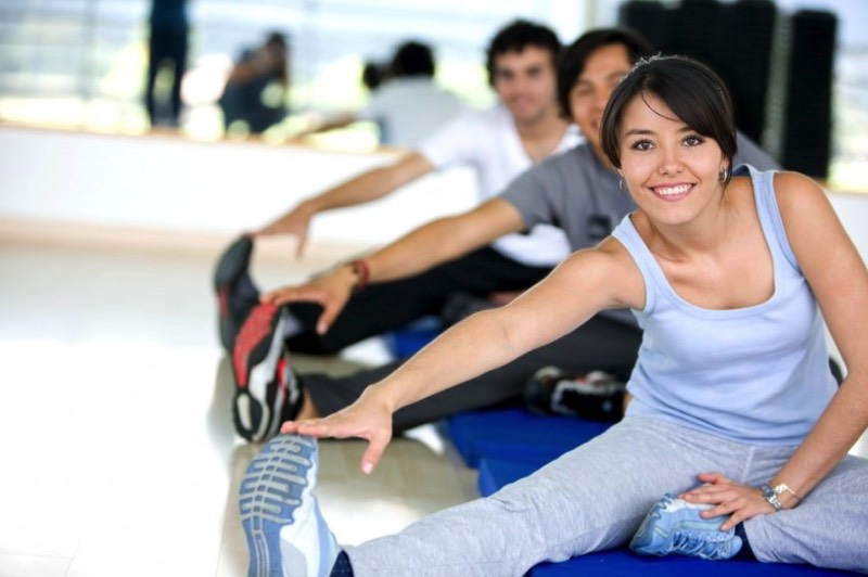 Image of Several People Stretching in a Group Fitness Class
